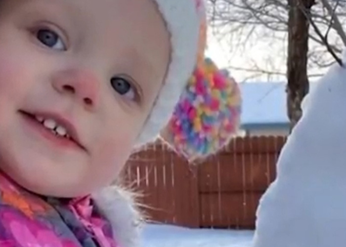 Young girl bundled in winter clothes outside near a snow figure, relating to mom's chilling Google searches and slaying case. Young girl bundled in winter clothes outside near a snow figure, relating to mom's chilling Google searches and slaying case.