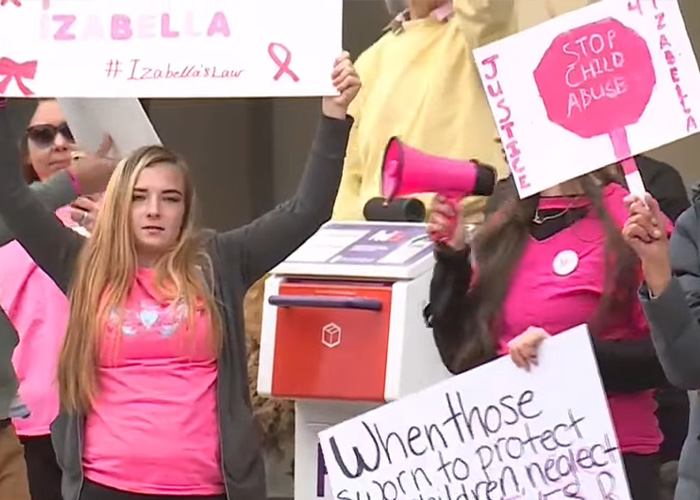 Protesters holding signs advocating justice and child a***e prevention in response to mom's chilling Google searches case. Protesters holding signs advocating justice and child a***e prevention in response to mom's chilling Google searches case.