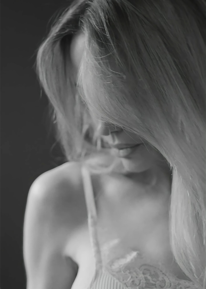 Black and white photo of a woman showing mastectomy scars, highlighting strength amid trolls targeting her image.