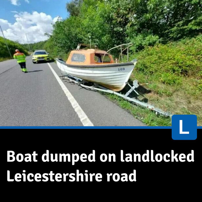 Small boat abandoned on a landlocked road in Leicestershire with emergency responders nearby, local newspaper headline visible