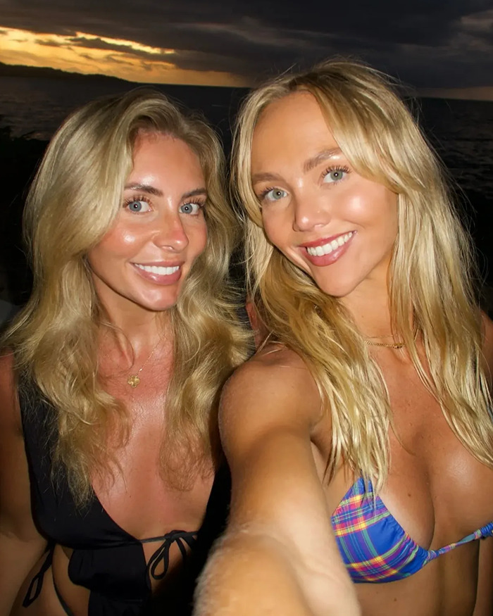 Adult stars Annie Knight and Bonnie Blue smiling for a selfie at sunset with ocean in the background. Adult stars Annie Knight and Bonnie Blue smiling for a selfie at sunset with ocean in the background.