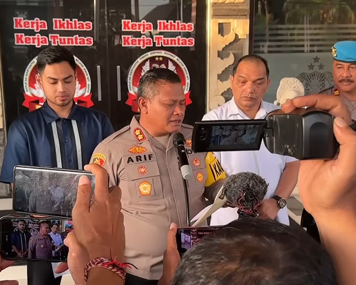 Police officer Arif giving a press statement as multiple reporters record the response to Bonnie Blue's arrest. Police officer Arif giving a press statement as multiple reporters record the response to Bonnie Blue's arrest.