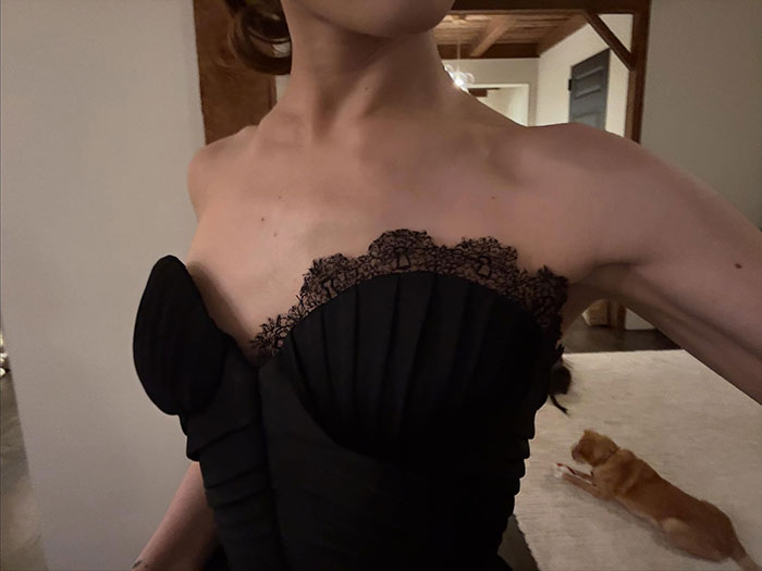 Close-up of a woman in a black lace dress highlighting a reminder about body-shaming awareness and self-acceptance.