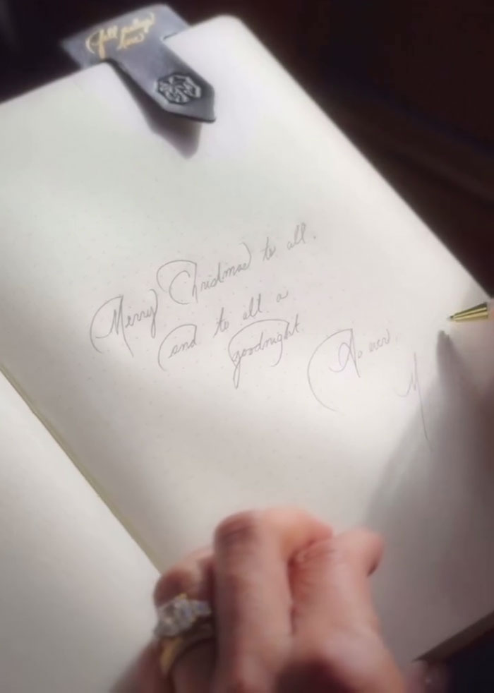Hand writing a Christmas message in a notebook, related to Meghan Markle's Christmas message and Prince Harry split rumors. Hand writing a Christmas message in a notebook, related to Meghan Markle's Christmas message and Prince Harry split rumors.