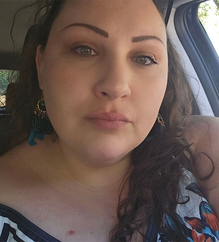 Woman with long dark hair sitting inside a car, related to cops revealing teen boys' revenge for setting girl on fire.