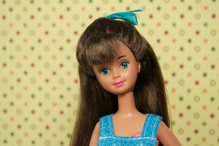 Doll with long brown hair and green eyes wearing a blue outfit, representing chaotic good moments shared by people.