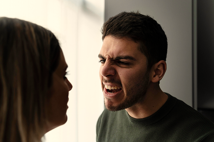 Upset boyfriend angrily confronting his girlfriend in an intense moment between a couple obsessed with relationship conflict. Upset boyfriend angrily confronting his girlfriend in an intense moment between a couple obsessed with relationship conflict.