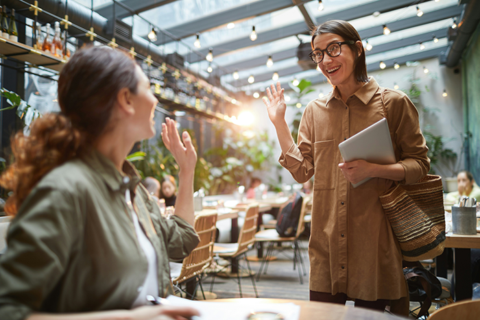 Upset girlfriend expressing frustration while her boyfriend looks obsessed during a tense moment in a cafe setting. Upset girlfriend expressing frustration while her boyfriend looks obsessed during a tense moment in a cafe setting.