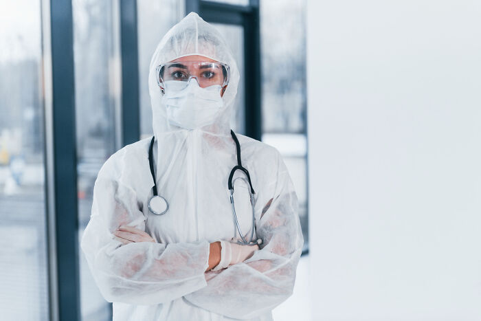 Healthcare worker in full protective gear and stethoscope, symbolizing the biggest bullet dodged in a medical crisis.