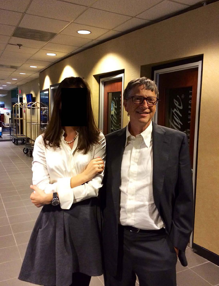 Man in glasses and suit standing next to woman with face obscured, linked to new Epstein files with photos marked messages.