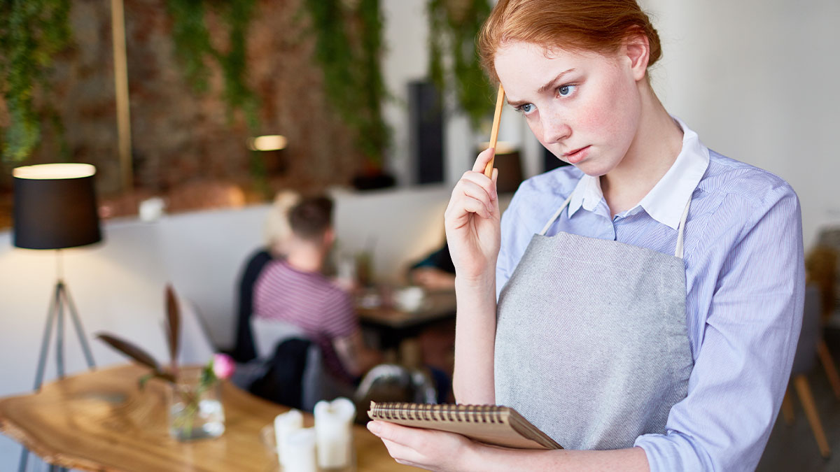 Waitress thinking seriously while dining out in a restaurant, showing entitled attitude and staff serving revenge.