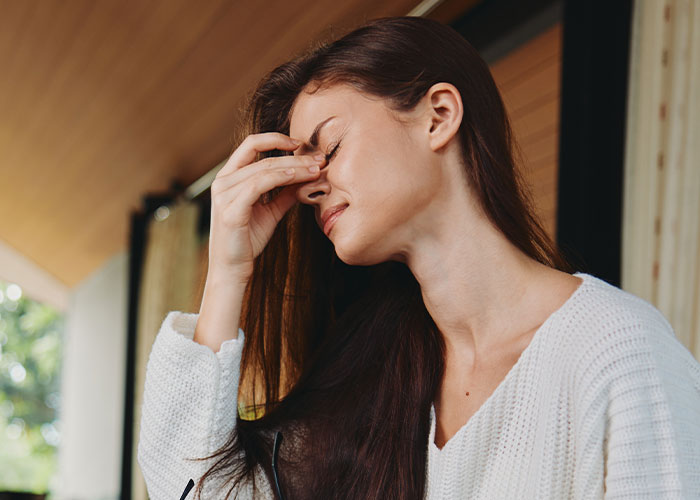Woman rethinking her engagement looking distressed after fiancé’s lie about her family causes tension during holiday dinner