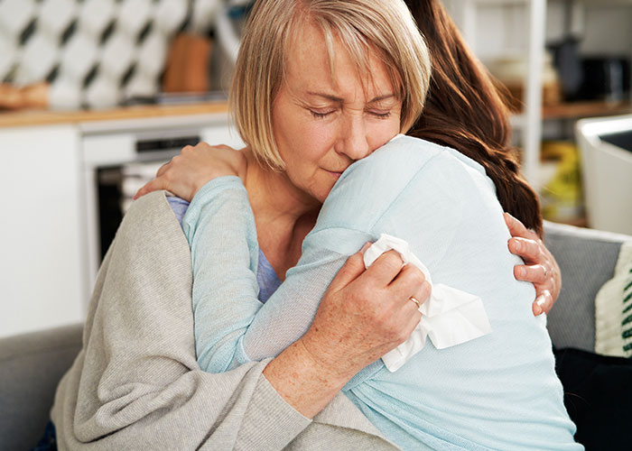 Woman rethinking engagement, emotional hug after fiancé’s lie about family revealed during holiday dinner, comforting moment