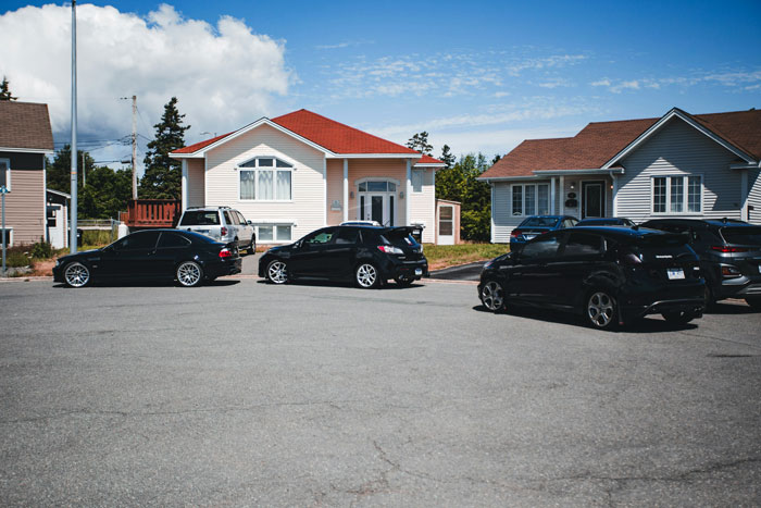Several cars blocking a driveway and nearby fire hydrant in a suburban neighborhood on a clear day Several cars blocking a driveway and nearby fire hydrant in a suburban neighborhood on a clear day