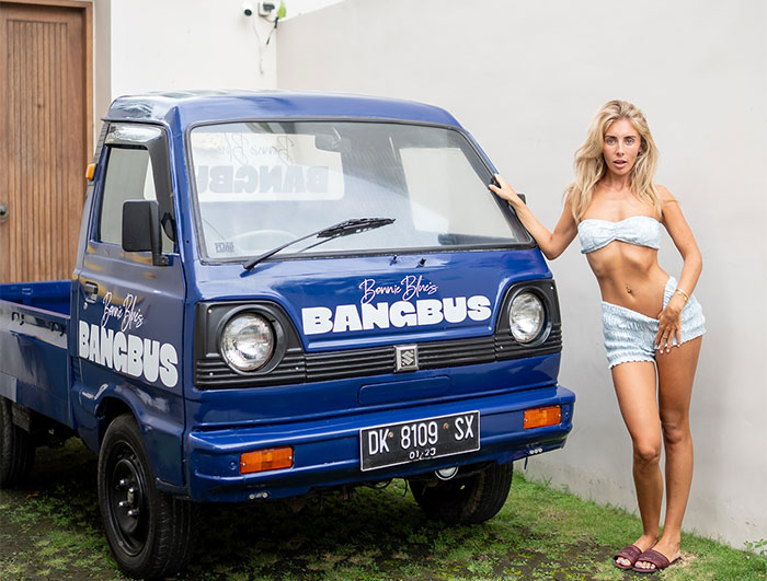 Bonnie Blue posing next to a blue Bangbus vehicle conveying a defiant message amid jail time threats. Bonnie Blue posing next to a blue Bangbus vehicle conveying a defiant message amid jail time threats.