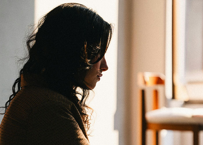 Silhouette of a man looking contemplative, representing man losing his girlfriend over a girl at work crush.