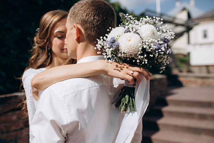 Woman rushes into marriage holding bouquet, showing emotional tension after financial instability and bitter reality check.