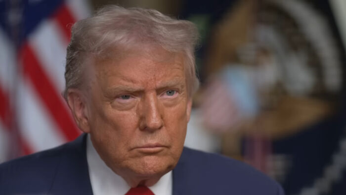 Man in suit and red tie in a formal setting, representing stories of small decisions with unexpected life-altering consequences.