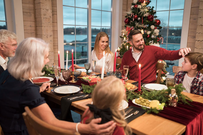 Family gathered around a festive Christmas dinner table, highlighting lazy relatives not bringing food to the meal. Family gathered around a festive Christmas dinner table, highlighting lazy relatives not bringing food to the meal.