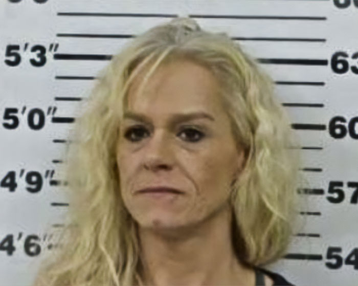 Mugshot of woman involved in incident where mom calls 911 after kids eat her gummies sparking arrest debate.