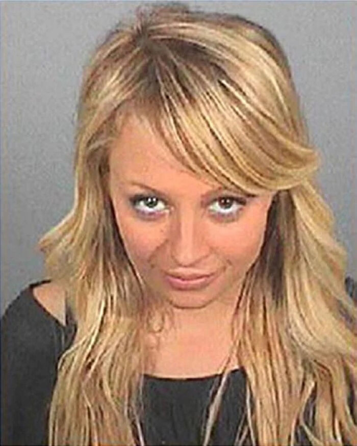 Blonde woman mugshot showing facial expression with disheveled hair, related to infamous celebrity mugshots keyword.