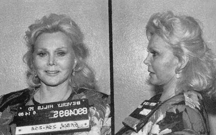 Black and white celebrity mugshot showing front and side profile of a woman with blonde hair and vintage clothing.