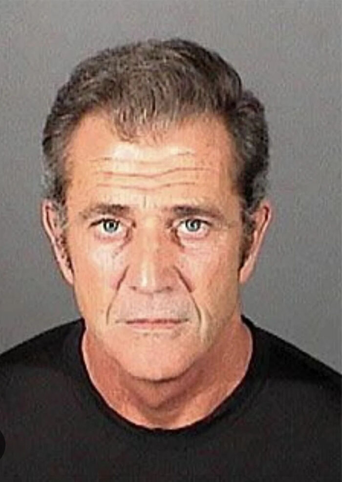Celebrity mugshot of a middle-aged man with serious expression, representing infamous celebrity mugshots and arrest reasons.