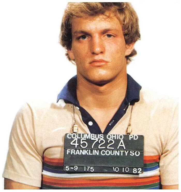 Young man in a mugshot photo wearing a striped shirt with police ID from Columbus Ohio, part of infamous celebrity mugshots.