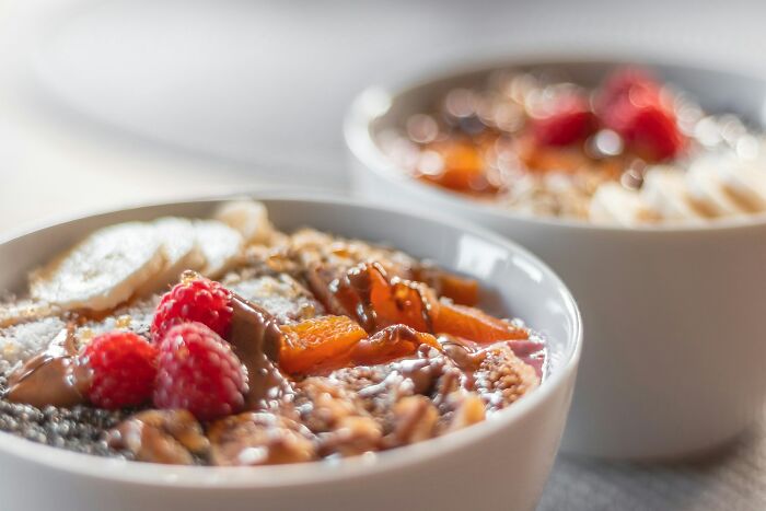 Close-up of healthy breakfast bowls with nuts, berries, and seeds highlighting everyday things more dangerous for health.