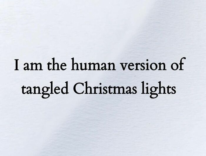 Funny Christmas meme text saying I am the human version of tangled Christmas lights on a light background.