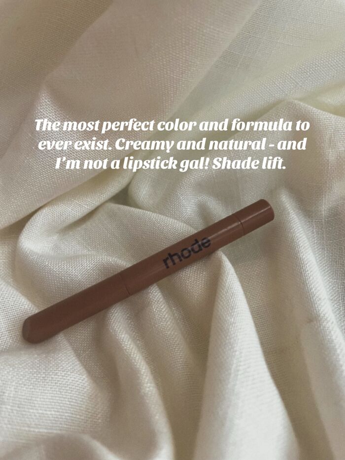 Brown Rhode lip crayon on soft fabric, a highly recommended Christmas gift praised for its creamy and natural formula.