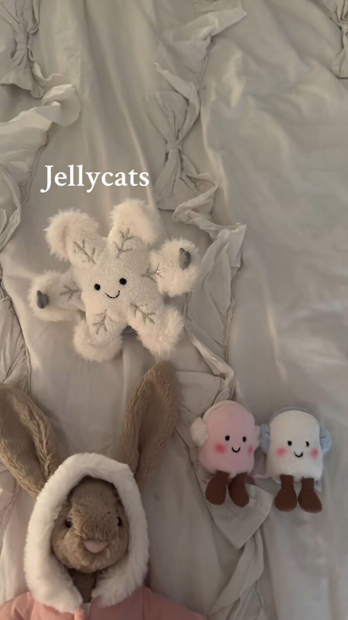 Plush Jellycats toys including a snowflake and bunny on a soft bed as popular Christmas gifts recommended by people.