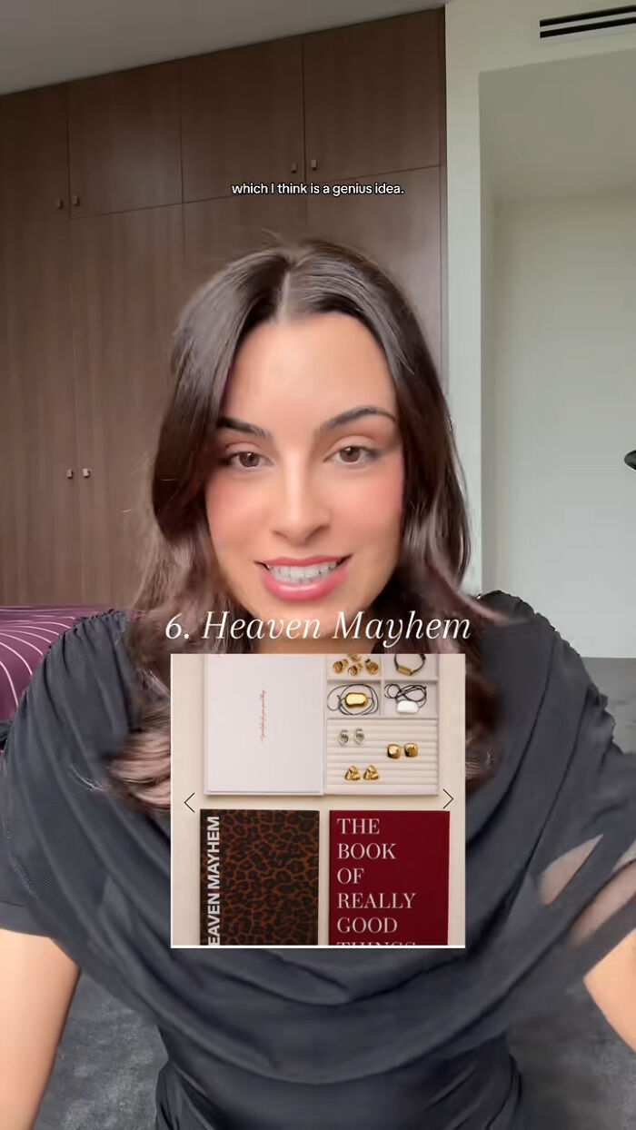Woman presenting Heaven Mayhem gift set, a top Christmas gift recommendation featuring jewelry and a book of good things.