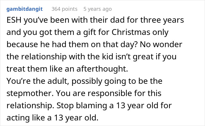 Screenshot of a Reddit comment discussing a 13-year-old's strained relationship with dad’s girlfriend and gift refusal regret. Screenshot of a Reddit comment discussing a 13-year-old's strained relationship with dad’s girlfriend and gift refusal regret.
