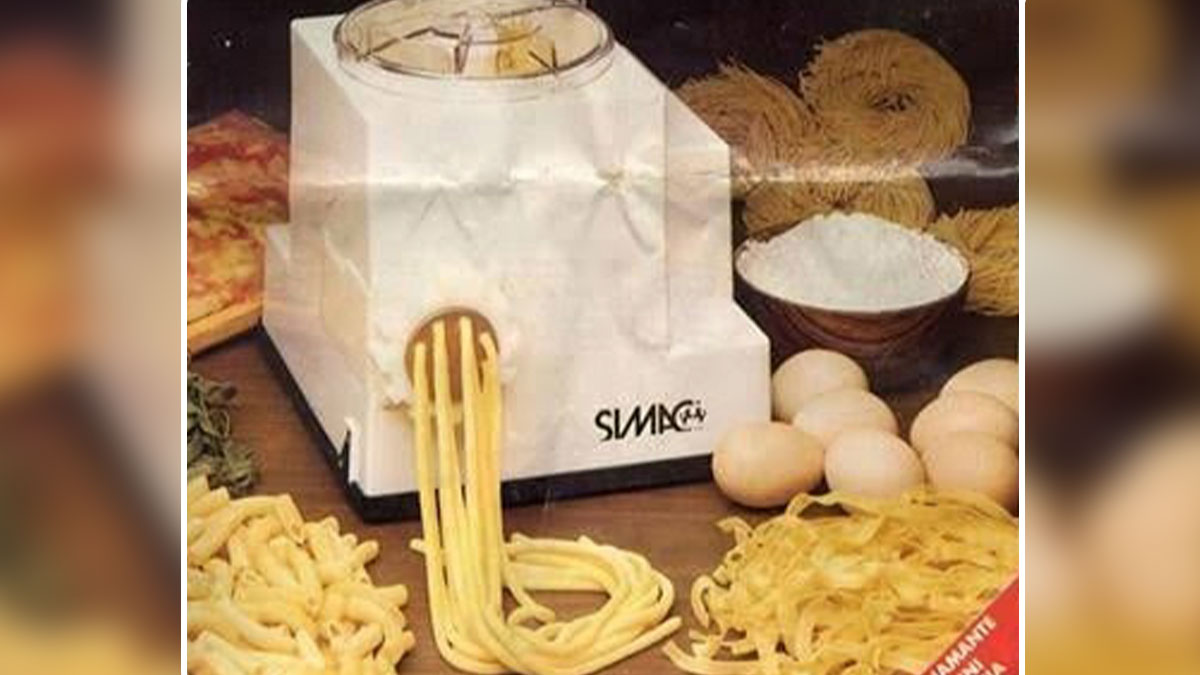 Vintage pasta maker machine with fresh pasta and ingredients, a country invention never made worldwide example.
