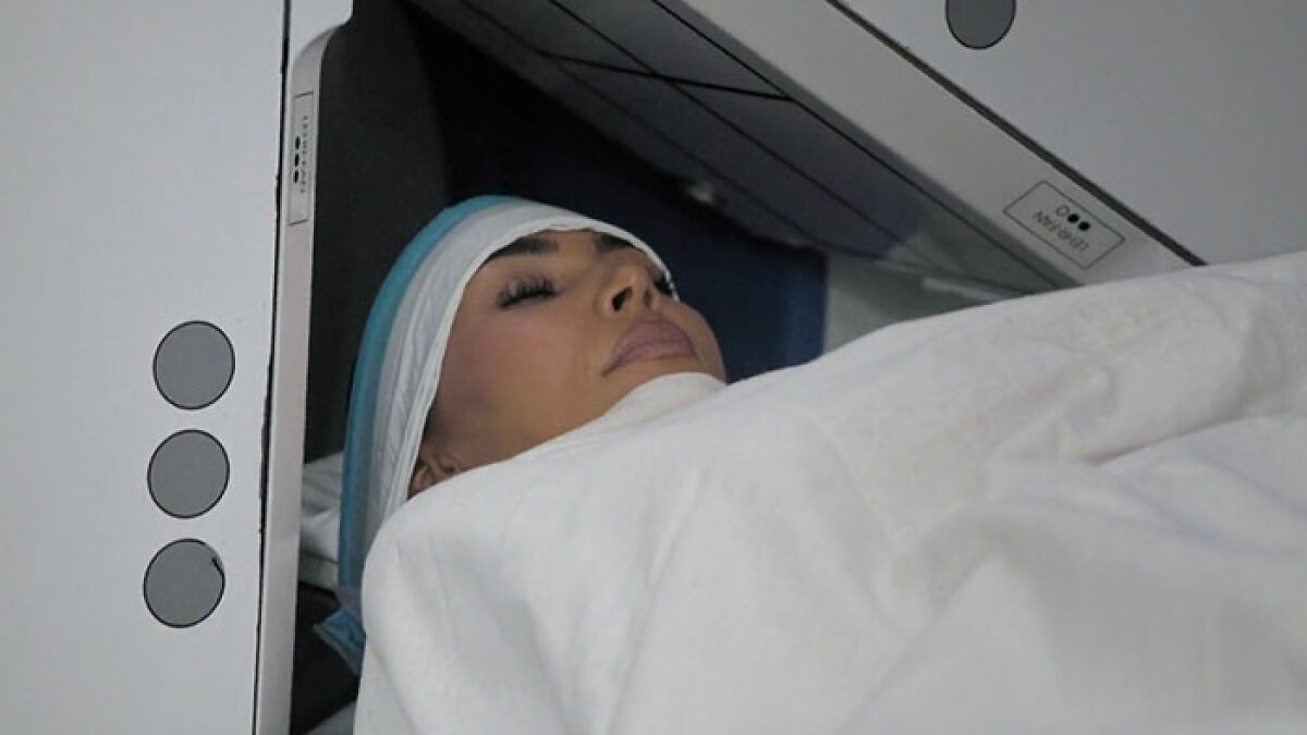 Kim Kardashian undergoing a brain scan, struggling to accept low brain activity results during medical imaging.