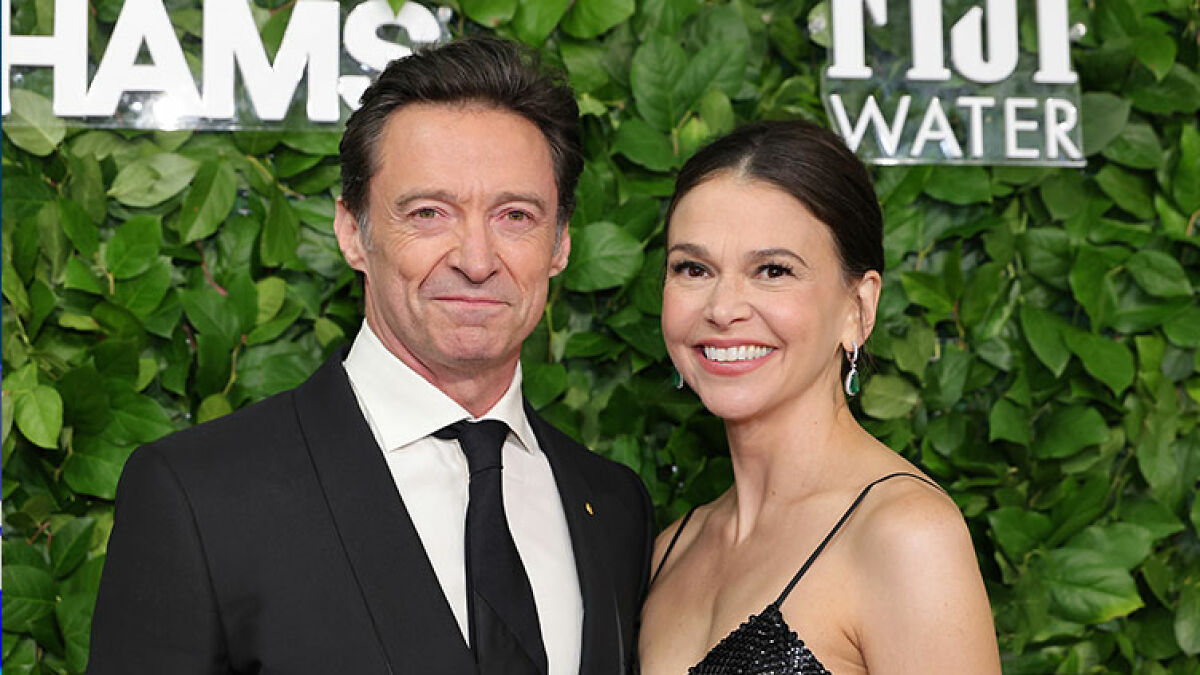 Hugh Jackman and Sutton Foster posing on the red carpet amid ongoing divorce controversy.