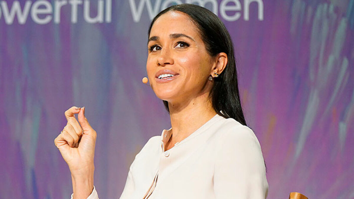 Meghan Markle speaking at an event, addressing the public amid outrage over contacting her estranged hospitalized father.