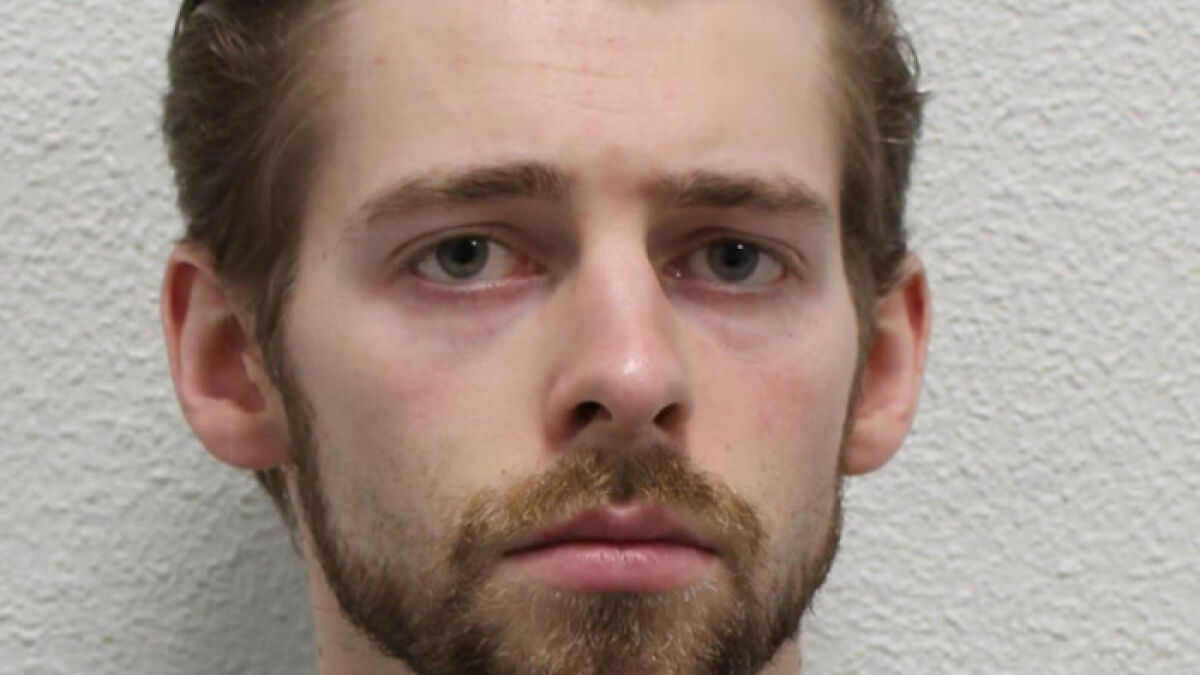 Close-up of a young man with a serious expression reflecting a wealthy US studentu2019s behavior after altercation.