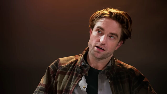 Actor in casual attire sharing a story during an interview about celebrities and unexpected encounters with mere mortals.