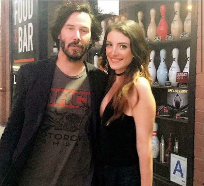 A casual encounter with a celebrity at a food bar, showing a fan posing happily with a famous actor.