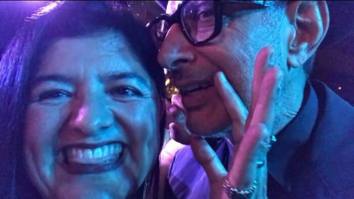 Two people smiling closely together, capturing a spontaneous moment in an unexpected celebrity encounter.