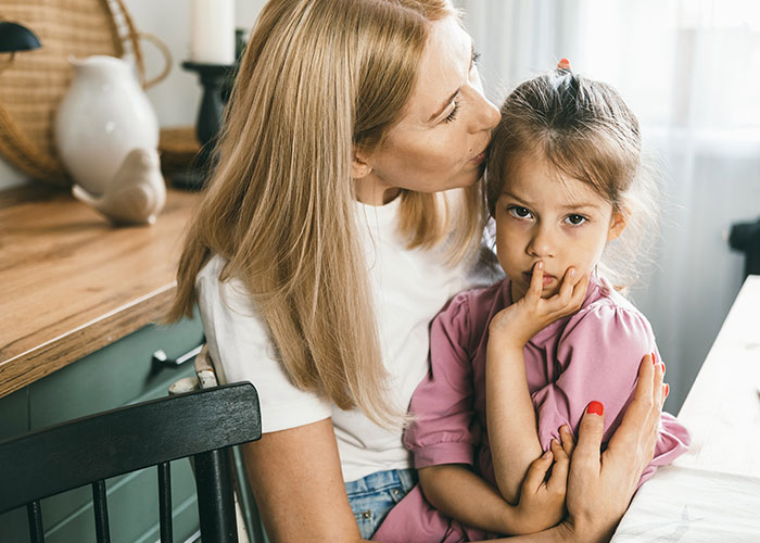 Mother comforting her daughter who looks worried, capturing the creepy things kids said that scared their parents.