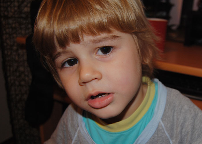 Young boy with a concerned expression, illustrating creepy things kids said that scared their parents.
