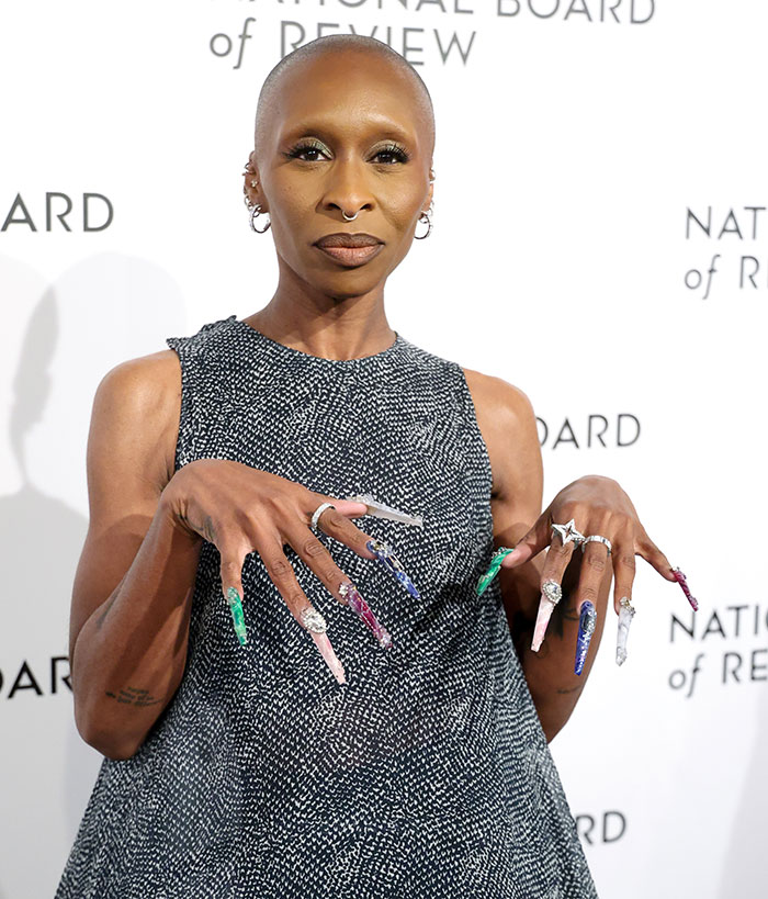 Cynthia Erivo posing with long colorful nails, reportedly in talks to play Lord Voldemort, sparking fan reactions.