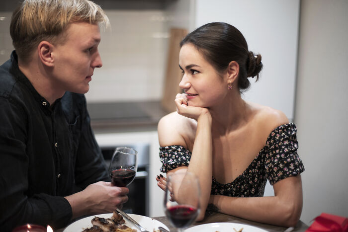 Couple on a date sharing a moment over wine, illustrating experiences of dating outside of their culture.