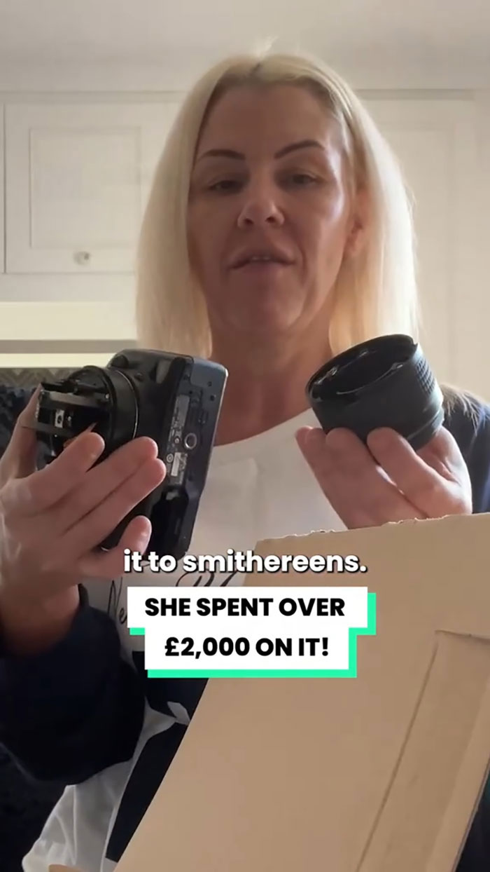 Woman holding broken camera lens and body, claiming Christmas gift was shattered by delivery driver with footage shown. Woman holding broken camera lens and body, claiming Christmas gift was shattered by delivery driver with footage shown.