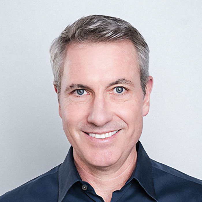 Headshot of a smiling man with gray hair and blue eyes wearing a dark shirt in a neutral background for HR exec Kristin Cabot. Headshot of a smiling man with gray hair and blue eyes wearing a dark shirt in a neutral background for HR exec Kristin Cabot.