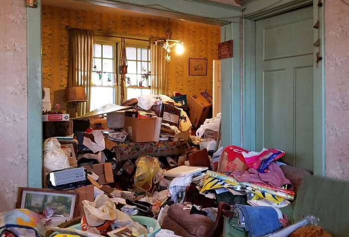 Cluttered living room filled with disturbing things found in homes of seemingly normal people, showing extreme hoarding disorder.