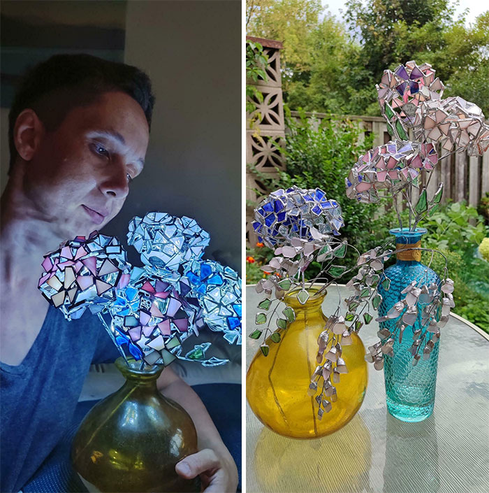 Man admiring cool handmade stained glass flowers in vases, showcasing creative and unique art people made to share.